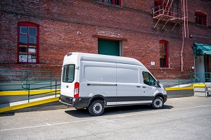 a van parked in front of a building